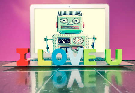 I LOVE U  with woden letters on a laptop on a wooden floorの写真素材