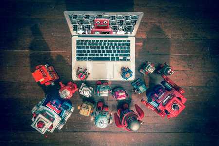 robot friends watch a film on a laptop  shot from above の写真素材