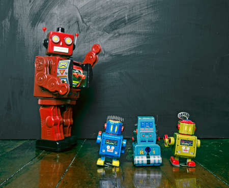Big red robot toy teaches his class , blackboard and copy spaceの写真素材
