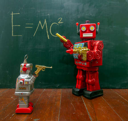 retro red robot techer at a blacboard with a ray gun の写真素材