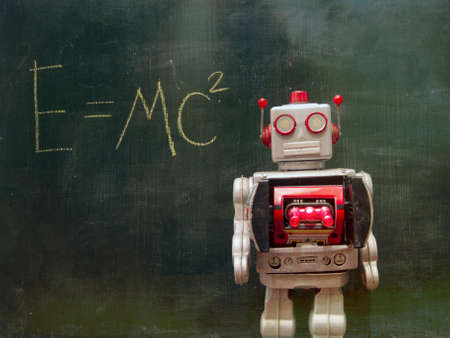 silver robot teacher at a blackboard with his gun doors open の写真素材