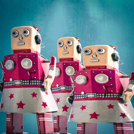 Three girl robot toys looking forward, toned imageの写真素材