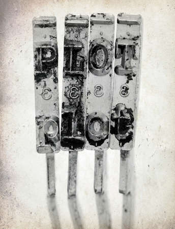 The word  PLOT with old typewriter hammers macro image on old paper の写真素材