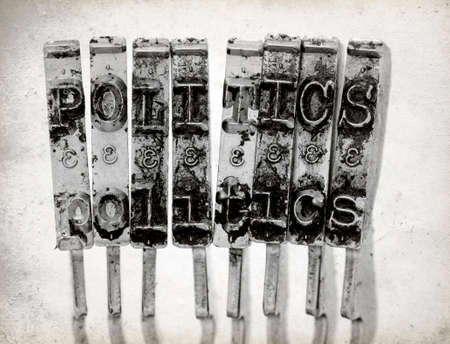 The word  POLITICS with old typewriter hammers macro image on old paper の写真素材