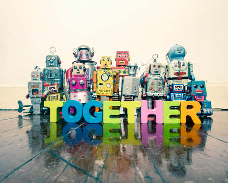 a team of vintage robots on a old wooden floor with the word TOGETHERの写真素材