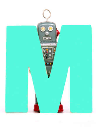 capital letter M held by vintage robot toysの写真素材