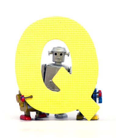 capital letter Q  held by vintage robot toys