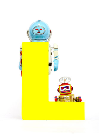 capital letter  L  held by vintage robot toys