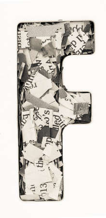 Capital letter made from cut up old newspaper Macro photographyの写真素材