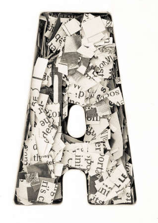 Capital letter made from cut up old newspaper Macro photographyの写真素材