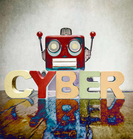 red retro robot head on the word   CYBER on old wooden florの写真素材
