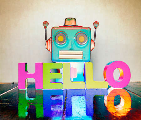 red talking head says hello on wooden floor with  reflectionの写真素材