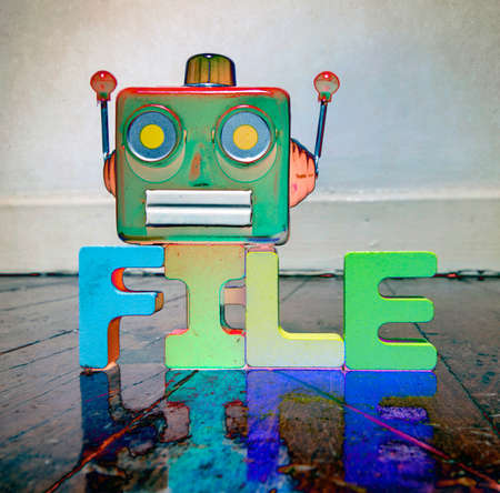 red retro robot head on the word FILE  on old wooden floorの写真素材