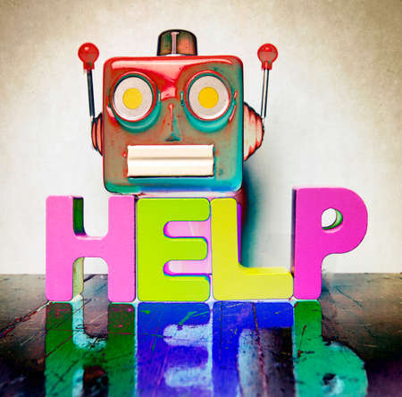 red retro robot head on the word FILE  on old wooden florの写真素材