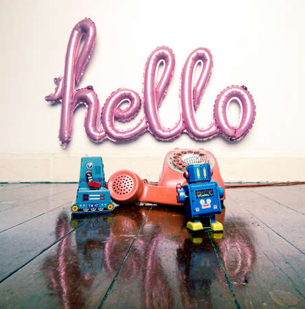 a hello balloon and two  robots on the phone  with reflection  bright colorの写真素材