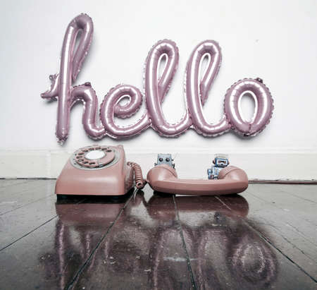 a hello balloon and two  robots on the phone toned imageの写真素材