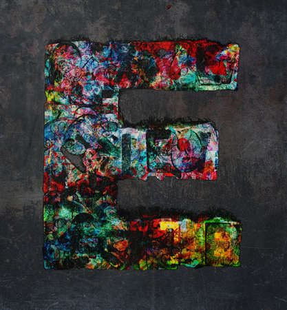 lots of small wooden letters to make up the letter A  graffiti style on a dark textured backgroundの写真素材
