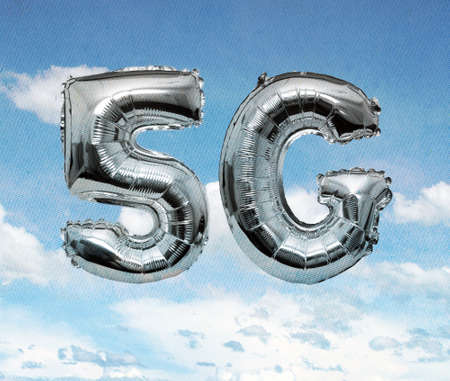 5G  silver baloons  in the skyの写真素材