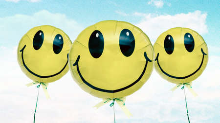 three happy ballons on a postcard blus sky  toned imageの写真素材