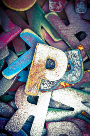 lots off old painted wooden letters  with the capital letter P in the middle bright color and tonedの写真素材