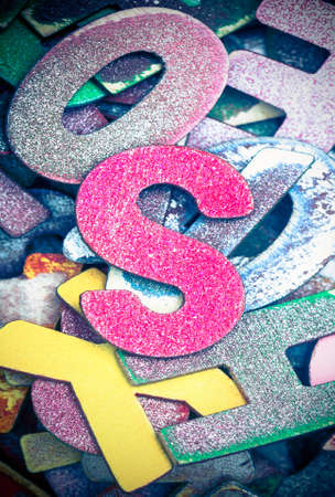 lots off old painted wooden letters  with the capital letter S  in the middle bright color and tonedの写真素材