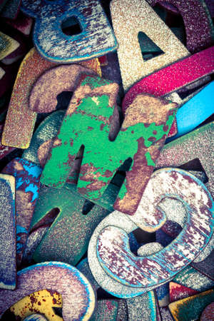 lots off old painted wooden letters  with the capital letter M  in the middle bright color and tonedの写真素材