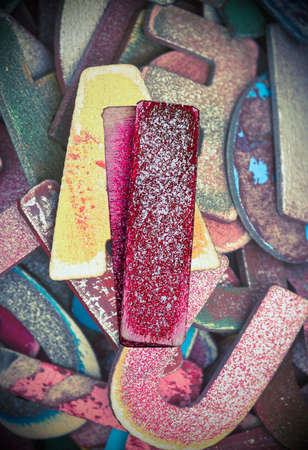 lots off old painted wooden letters  with the capital letter I in the middle bright color and tonedの写真素材