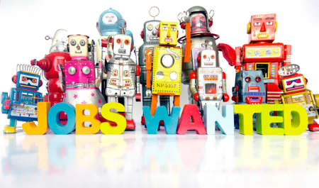 a large team of retro robots with the word JOBS WANTED on a bright white backgroundの写真素材