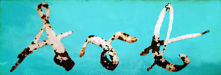 painted and rusted word Art on a turquoise wall backgroundの写真素材