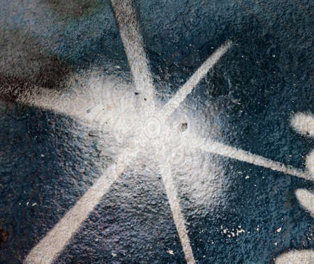 white painted srar busts on an old wallの写真素材