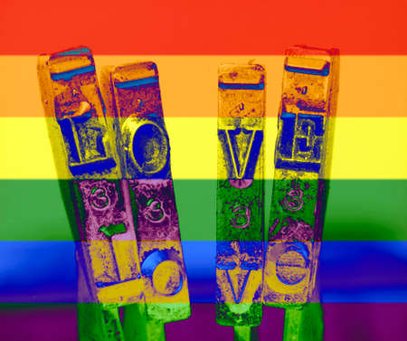 the word love with old typewriter hammers macro  rainbow colors abstractの写真素材