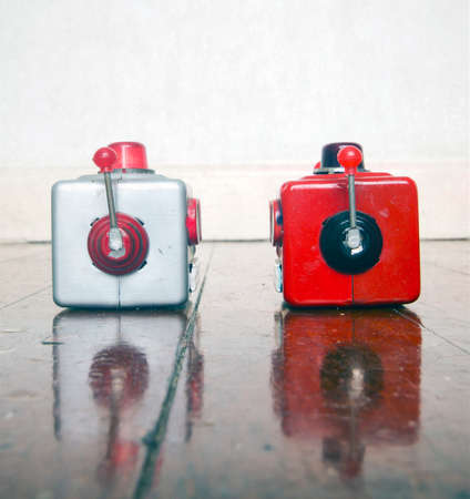 two metal robot heads chatting on a wooden floor with copy space,の写真素材