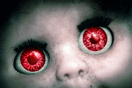 macro image of a old spooky doll,s   red eyesの写真素材
