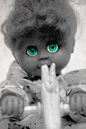 old doll on a rocking horse  tone spooky image  in monochrome の写真素材