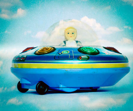 vintage ufo toy in the cloudsの写真素材