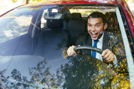 Shocked driver in the car, frightened man driving.の写真素材