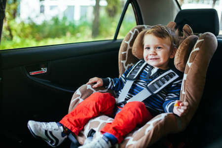 Adorable baby boy in a safety car seat.の写真素材