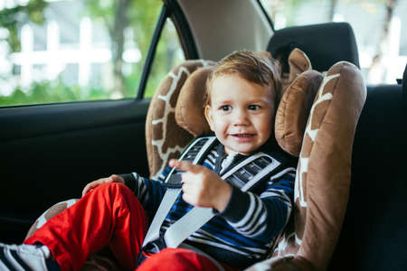 Adorable baby boy in a safety car seat.の写真素材