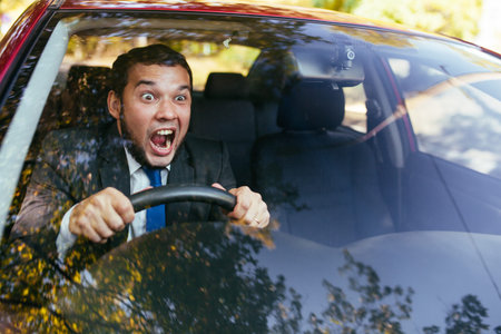 Shocked driver in the car, frightened man driving.の写真素材