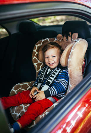 Adorable baby boy in a safety car seat.の写真素材