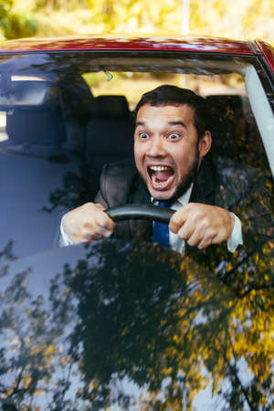 Shocked driver in the car, frightened man driving.の写真素材