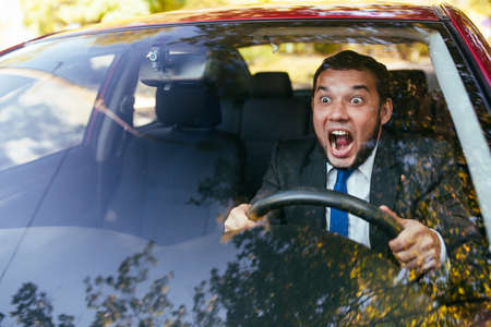 Shocked driver in the car, frightened man driving.の写真素材
