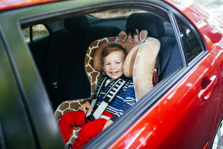 Adorable baby boy in a safety car seat.の写真素材