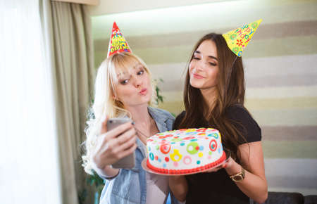 Girls make selfie at a birthday partyの写真素材
