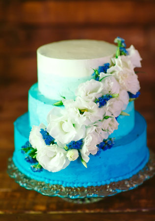 Wedding cake with roses as sweet treat and dessert