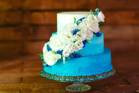 Wedding cake with roses as sweet treat and dessert