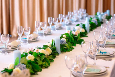 Wedding table settings. Empty plates and glasses on a white tablecloth.の写真素材