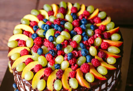Fruit, cake naked. homemade cake with raspberries, grapes, and peach slices.の写真素材