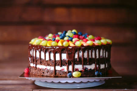 Fruit, cake naked. homemade cake with raspberries, grapes, and peach slices.の写真素材