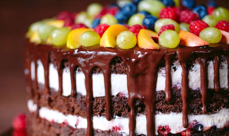Fruit, cake naked. homemade cake with raspberries, grapes, and peach slices.の写真素材
